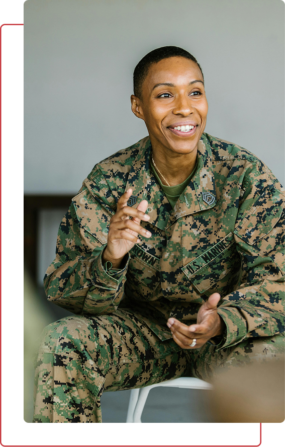 Marine in digital camouflage uniform sitting